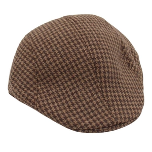 Close-up of brown houndstooth pattern fabric on a classic British flat cap
