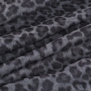 Detailed macro view of dark grey leopard print mesh fabric with breathable hole structure