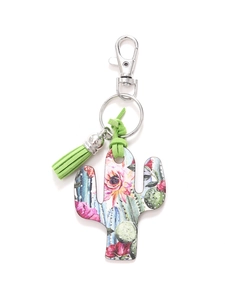 Detail of wooden cactus keychain with green tassel and metallic clasp on white background