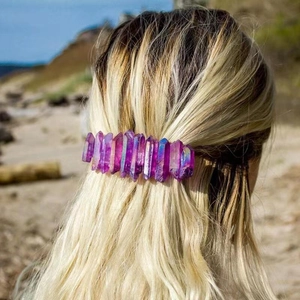 Detail view of a handmade purple crystal spring hair clip on a model's blonde hair