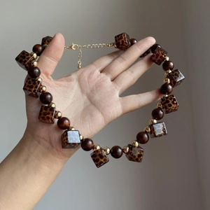 Vintage leopard print acrylic and wooden bead necklace with adjustable gold chain