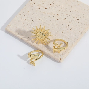Detailed shot of gold-plated sun, whale tail, and hammerhead shark adjustable rings set