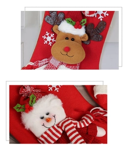 Close-up of reindeer and snowman 3D plush characters on red knitted Christmas stockings
