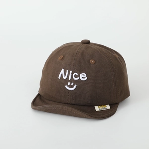 Close-up of nice smiley embroidery and brand label on brown soft brim kids cap