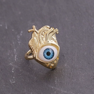 Detailed view of an 18K gold anatomic heart ring with a realistic blue evil eye center