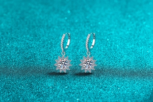 Macro shot of silver sunflower earrings featuring central moissanite and surrounding diamonds