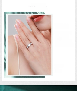 Three-stone silver ring featuring a round center zircon and pear-shaped side diamonds