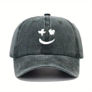 Detail view of washed cotton baseball cap with white graffiti smile and heart eyes logo