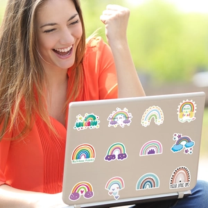 Rainbow and unicorn stickers applied on a laptop back for creative decoration