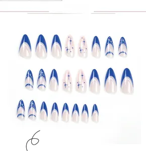 Detail of 24 pieces almond-shaped press-on nails with blue French tips and star patterns