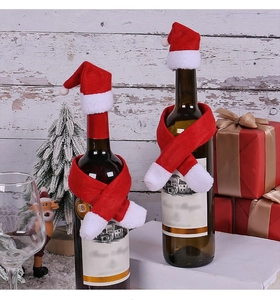 Detail of red Christmas wine bottle scarf and hat set on festive background