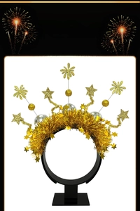 Detail of festive gold firework headband with sparkly stars and disco ball accents