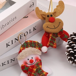 Detailed view of Christmas reindeer and snowman plush hanging ornaments on a white background