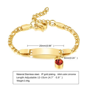 Close-up of gold plated stainless steel bracelet with ID plate and red cubic zirconia