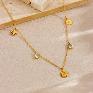 Detail of gold-plated starfish and floral pendants on an ocean-themed necklace