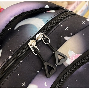 Detail of double-way zippers on star moon print backpack with triangular pullers