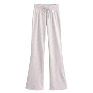 Detail of light gray knitted flare pants showing drawstring waistband and soft texture