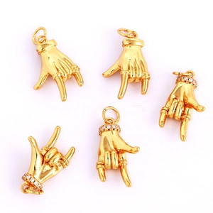 Detailed view of hand-shaped gold pendants with zircon inlay and smooth finish for DIY jewelry