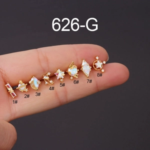 Close-up of tiny gold-plated stainless steel stud earrings set with iridescent opals