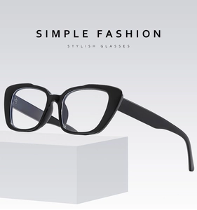 Detail of minimalist black cat-eye glasses frame on a white geometric block base