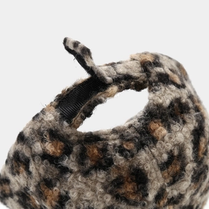 Close-up of leopard print velvet baseball cap featuring adjustable velcro strap detail