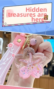 Macro detail of acrylic cherry blossom keychain with pink starfish and liquid sequins