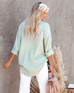 Detail view of mint green textured long sleeve shirt back with natural drape and relaxed fit