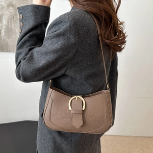 Chic brown crescent hobo bag with pebble leather texture and gold D-ring buckle