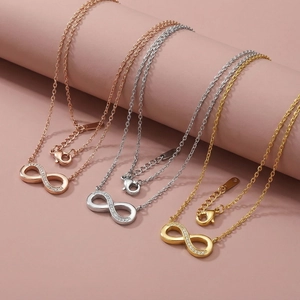 Detailed view of infinity necklaces in gold, silver, and rose gold with pavé crystals