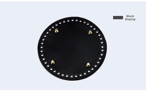 Detail of 15cm round black leather bag bottom with gold studs and pre-drilled holes