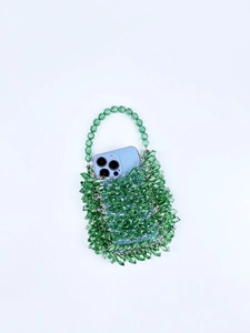 Detail of green handmade acrylic beaded handbag showing texture and interior capacity