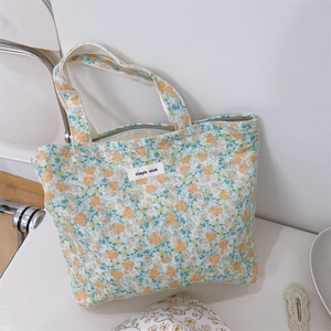 Detailed view of the simple wish floral canvas tote bag with a secure zipper closure