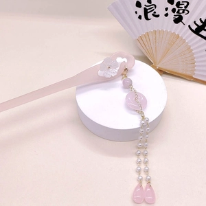 Detail of pink acetate flower hair pin with long tassels and faux pearls in Chinese style