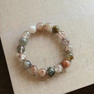 Detailed view of colorful rutilated quartz beads showing natural mineral inclusions