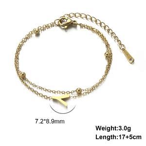 Detail of gold-plated double-layer stainless steel bracelet with letter Y pendant