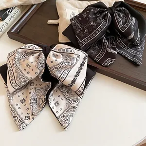 Elegant paisley bow shark hair clip in black and cream satin for stylish hair styling