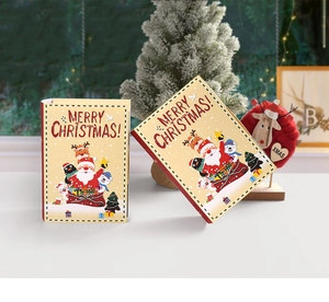 Detail of creative magic book Christmas candy boxes with Santa and reindeer illustrations