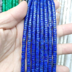 Detailed close-up of dark blue cylindrical natural stone spacer beads for DIY jewelry