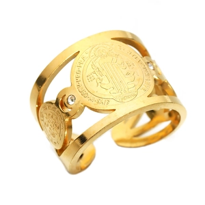Detailed close-up of a wide gold-plated stainless steel ring with St. Benedict Medal design