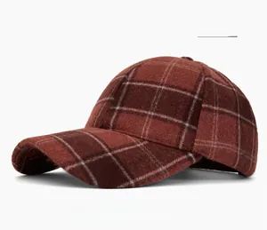 Detail view of red plaid baseball cap fabric and classic six-panel stitching structure