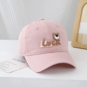 Detailed view of pink cotton kids baseball cap with Luck bear silicone applique