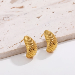 Detailed close-up of 18K gold plated croissant earrings with geometric texture
