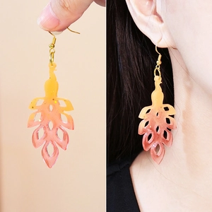 DIY resin feather earrings with orange gradient finish and metal hooks for jewelry making