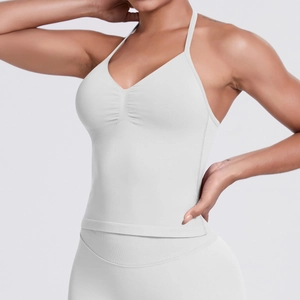 Detail of white seamless yoga top featuring a V-neckline and gathered chest design