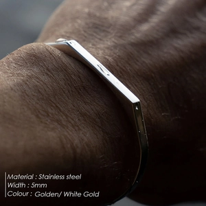 Detail shot of a 5mm minimalist geometric stainless steel bangle in white gold finish
