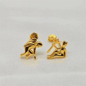 Artistic gold S925 sterling silver asymmetric human figure stud earrings on white velvet