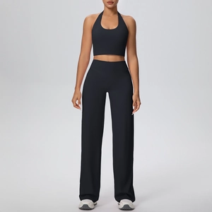 Detailed view of black halter yoga set with slim sports bra and wide-leg trousers