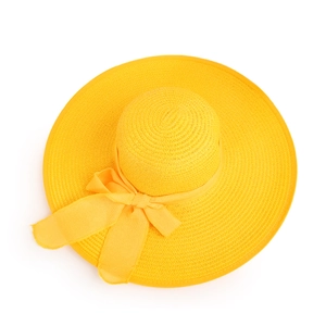 Top-down view of a bright yellow straw sun hat with wide brim and decorative bow