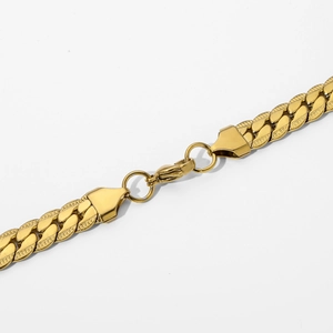Close-up of golden stainless steel Cuban chain necklace with textured links and lobster clasp