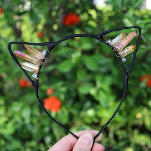 Macro view of crystal cat ear headband with rainbow stones and gold bead detailing